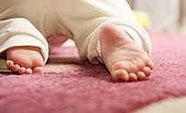 Child crawling on carpet